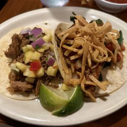 Pork carnitas taco with pineapple salsa and Salmon taco
