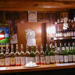 rows of wine bottles lined up on a bar