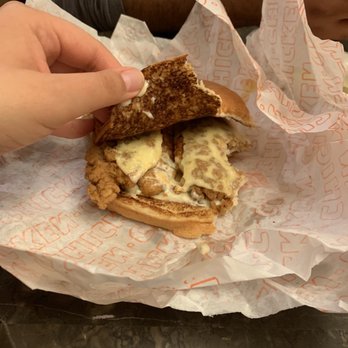 Whataburger - a person taking a bite out of a sandwich - Burgers Near Me - Rio Rancho, New Mexico