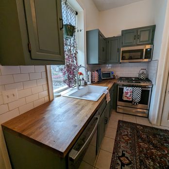 Dymor Construction - a kitchen with a sink and stove - Painters Near Me Dymor Construction - a kitchen with a sink and stove - Painters Near Me