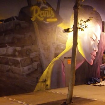 East Village - a mural of a woman's face on the side of a building - Nightlife Near Me - San Diego, California