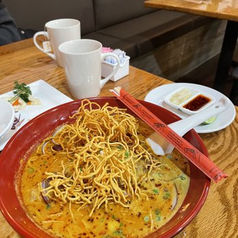 Thai Thai Cuisine - Khao Soy... buried in this hearty coconut soup is a Chicken Thigh and rice noodles. My favorite over curry option. - Asian Fusion Near Me - Indianapolis, Indiana