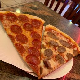 two slices of pepperoni pizza on a paper plate two slices of pepperoni pizza on a paper plate