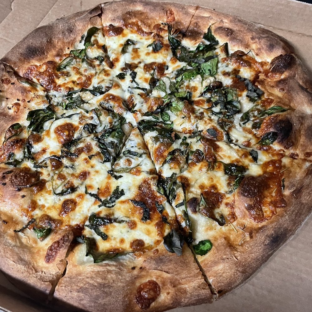 Mia Marco's Pizza - White pizza with grilled spinach. - Food Trucks Near Me - Selma, Texas Mia Marco's Pizza - White pizza with grilled spinach. - Food Trucks Near Me - Selma, Texas