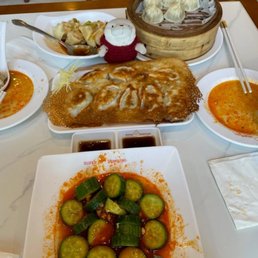 Cucumber salad, Xiao Long bao, panfried pork and chives dumplings, shrimp and pork wonton in chilli oil. Cucumber salad, Xiao Long bao, panfried pork and chives dumplings, shrimp and pork wonton in chilli oil.