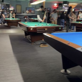 The Grand - a pool table with a pool ball on it - Pool Halls Near Me - Austin, Texas