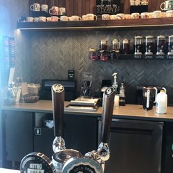 Starbucks - Nitro and Cold Brew on tap with fresh teas in the background. Various been there mug collection is fun to look at.