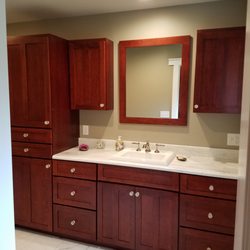 Cornerstone Woodworking - Bathroom remodel: Holiday Kitchens Cherry cabinets w/ Acorn stain. Seattle Duet door style and 5 piece drawer front. Cararra Marble tops