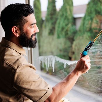 Rodriguez Window Cleaning - Finishing interior side of windows with a smile - Window Washing Near Me