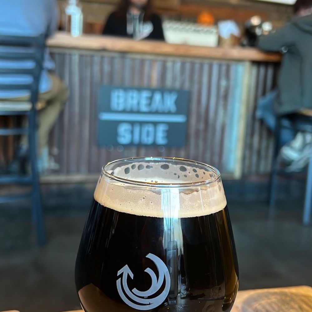 a glass of beer on a table a glass of beer on a table