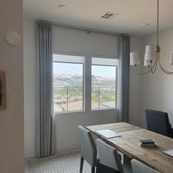 Dreamhouse - Decorative Curtain panels paired with light filtering Roller Shades.