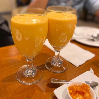Karavalli - two glasses of orange juice on a table - Indian Near Me - Latham, New York Karavalli - two glasses of orange juice on a table - Indian Near Me - Latham, New York
