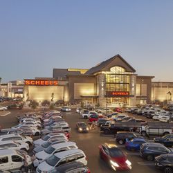 Chandler Fashion Center - Evening view of the Scheels exterior and busy parking lot at Chandler Fashion Center.