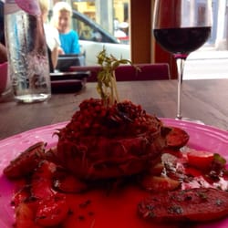 Justus K - Artichoke heart stuffed with wheat accompanied with vegetables and a glass if Shiraz