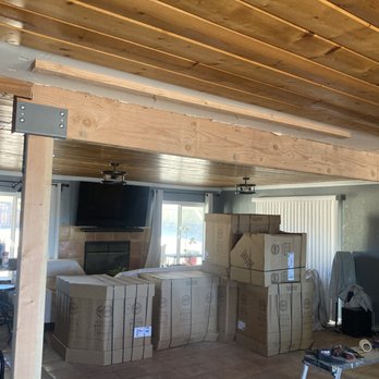 L&H Construction - a living room with boxes and a television - General Contractors Near Me L&H Construction - a living room with boxes and a television - General Contractors Near Me