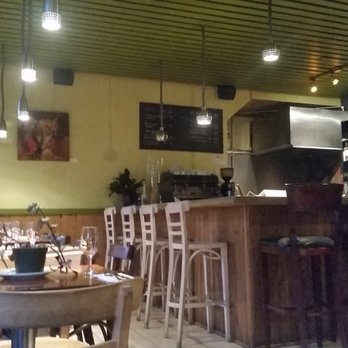 Boustifaillon - a table and chairs in a restaurant - French Near Me - Montreal, Quebec Boustifaillon - a table and chairs in a restaurant - French Near Me - Montreal, Quebec