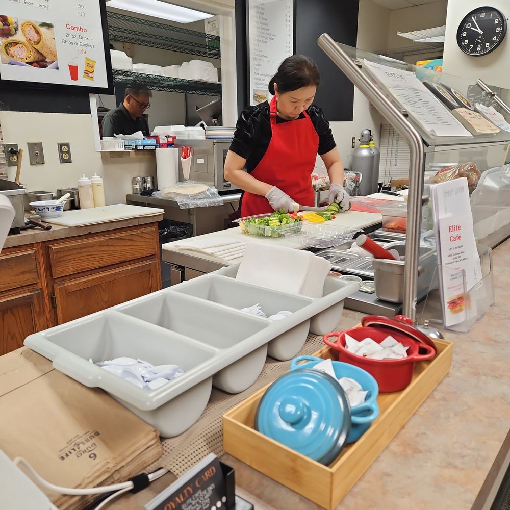 Elite Cafe - Helen preparing salad, fresh cutting veggies with care. - Delis Near Me - Overland Park, Kansas
