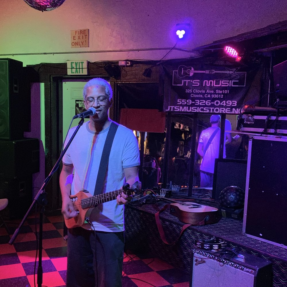 Intimo Cocktail Lounge - a man playing a guitar - Cocktail Bars Near Me - Fresno, California
