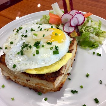 Bonjour Cafe - Croquet Madame homemade bread, turkey, ham, gruyere, Swiss, chives and a fried egg on top, a green salad with a  French vinaigrette. - Cafes Near Me - Katy, Texas