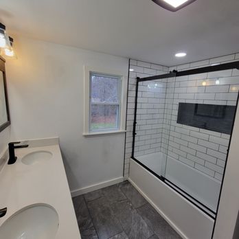 Milkins Carpentry - a bathroom with a shower and sink - General Contractors Near Me - Scotia, New York