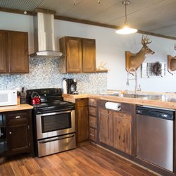Sandstone Point Vacation Cabin - Kitchen with full size frig, stove, dishwasher and microwave.  Furnished with pots/pans and dishes.
