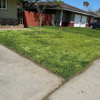 Ez Lawn Landscape - a house with a car parked in front of it - Landscaping Near Me