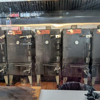 Meat Moot Smoking - The smokers behind a Plexi-glass screen. - Smokehouse Near Me - Novi, Michigan
