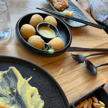 Yunta Nikkei - Yucca balls with yellow aji sauce. - Peruvian Near Me - Charlotte, North Carolina