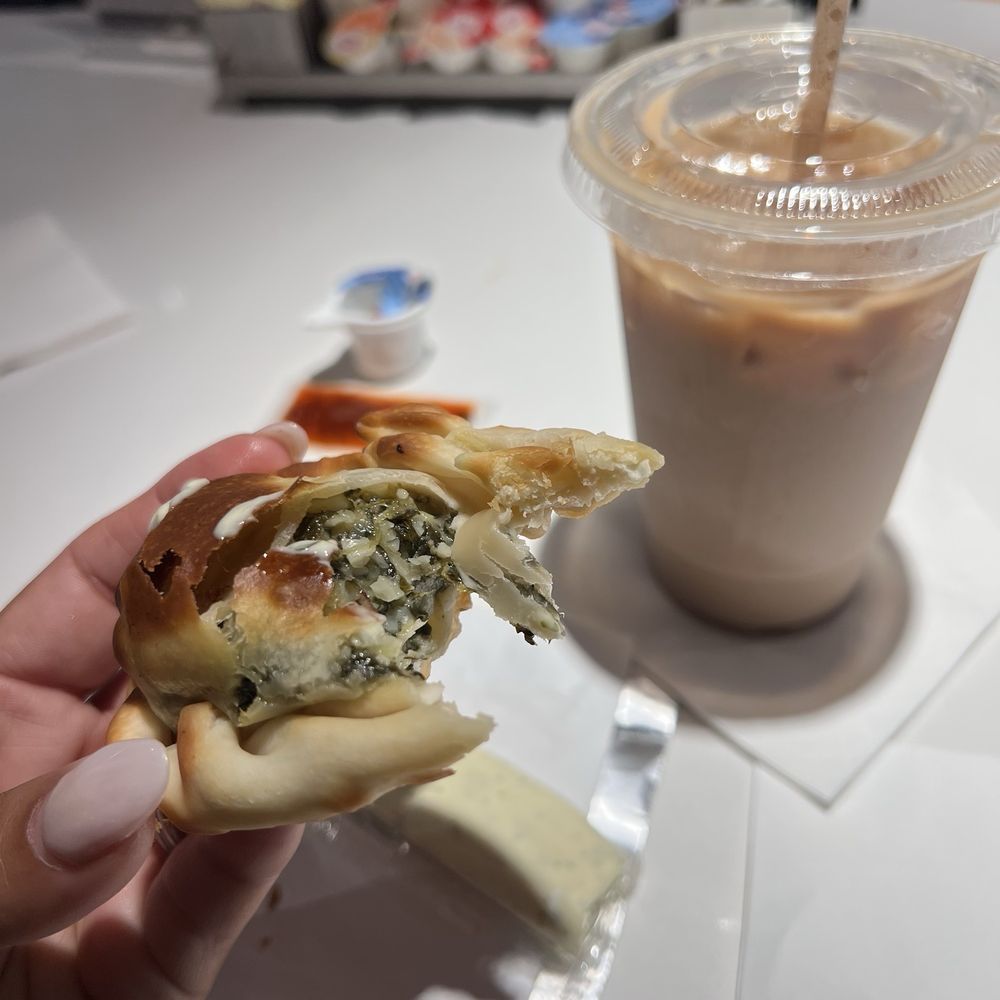 Brightline Orlando Station - Enjoying a spinach & feta empanada and iced Cuban coffee before boarding - Train Stations Near Me - Orlando, Florida Brightline Orlando Station - Enjoying a spinach & feta empanada and iced Cuban coffee before boarding - Train Stations Near Me - Orlando, Florida