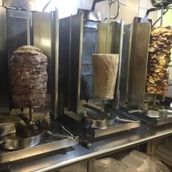 Babylon Pizza & Shawarma - Shawarma Meat inside on stand up cookers.