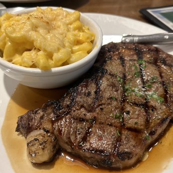 Bunkers Sports Bar - 12 oz ribeye medium rare juicy and delicious! MAC and cheese served hot and creamy! - American Near Me