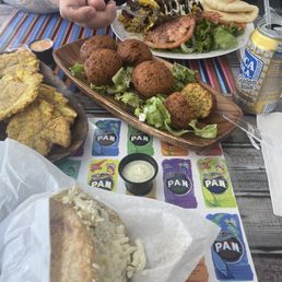 Arepa Pepiada, Falafel, Schwarma plate & tostones.