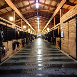 Brookfield Farms Equestrian Center - Inside the barn. Mats freshly swept and cleaned!