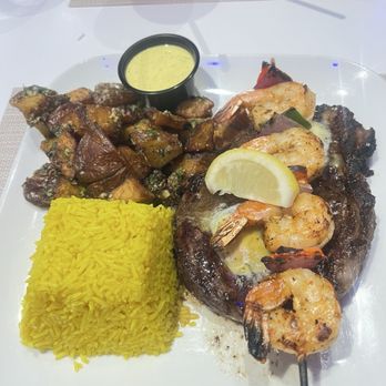 Fusion Restaurant & Bar - Ribeye meal with shrimp, basmati rice and fried potatoes and dill sauce - Mediterranean Near Me - Mcdonough, Georgia