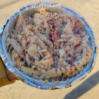 Yummys - a person holding a pizza in a foil container - Burgers Near Me - Farmville, Virginia Yummys - a person holding a pizza in a foil container - Burgers Near Me - Farmville, Virginia