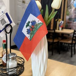 Golden Bees - Haitian flags on the table.