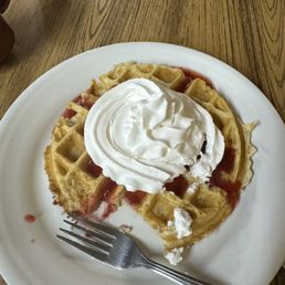 a waffle with whipped cream on top