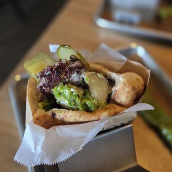 Miznon - Lamb Kebab Pita- Grilled Tomato and Onion, Tahini, Pickles, Spicy Green Peppers - Mediterranean Near Me - Los Angeles, California Miznon - Lamb Kebab Pita- Grilled Tomato and Onion, Tahini, Pickles, Spicy Green Peppers - Mediterranean Near Me - Los Angeles, California