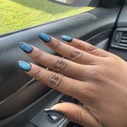 The nails she did on me. Terrible execution of the cats eye. It's not subtle at all. The blue just looked slapped on there.