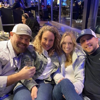 Topgolf - Keeping warm under the heater in between hits! - Golf Near Me - Ashburn, Virginia Topgolf - Keeping warm under the heater in between hits! - Golf Near Me - Ashburn, Virginia