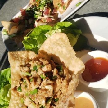 Yard House - Poke Nachos- scallion, serranos, white truffle sauce, soy ginger sauce. Chicken lettuce wraps with sweet chili, peanut sauce. - Bars Near Me - Long Beach, California