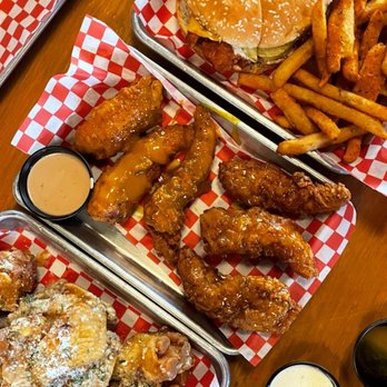 Gold Feather - bottom: garlic parm wings; middle: honey badger tenders, easy tiger tenders, ole smokey sauce; top: spicy tatanka burger - Beer Bar Near Me - San Antonio, Texas