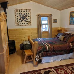 Elijah's Rest Cabins and Breakfast - Inside the small cabin: queen bed, TV, sm table, microwave, mini fridge, and optional roll out bed. Can sleep 3.  Clean and bright.