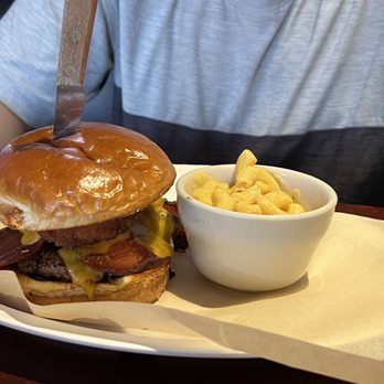 The Tap Room - Bison bacon cheeseburger with onion rings and bbq sauce. Mac and cheese on the side. - Sports Bars Near Me - Lewiston, Idaho The Tap Room - Bison bacon cheeseburger with onion rings and bbq sauce. Mac and cheese on the side. - Sports Bars Near Me - Lewiston, Idaho