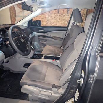 EJ3 Customs - The image displays the interior of a Honda vehicle, focusing on the front seats, steering wheel, and dashboard, with a view of the driver's side and passenger seat. - Auto Detailing Near Me - Aurora, Colorado