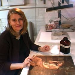 Elzbieta Osiak-Heise cleans and repairs a Victorian painting.