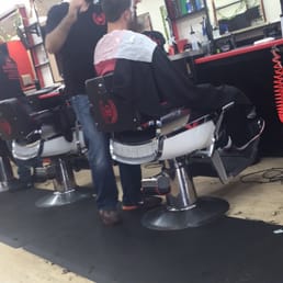 Nick giving a cut to his customer. Nick giving a cut to his customer.