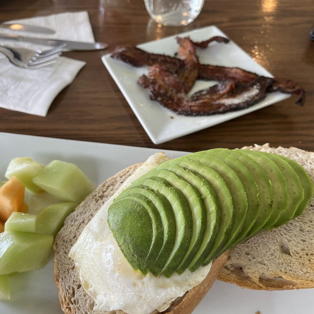 The Friendly Fox - Avocado toast with egg and bacon...I subbed out the English muffin for their house made bagel. Delish. - Cafes Near Me - Fort Wayne, Indiana The Friendly Fox - Avocado toast with egg and bacon...I subbed out the English muffin for their house made bagel. Delish. - Cafes Near Me - Fort Wayne, Indiana