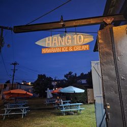 Hang 10 - The outdoor sign of the place at night.