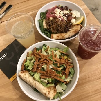 CAVA - Two greens + grains bowls with the mini pita that comes on the side. Classic lemonade and Blueberry Lavender drink. - Mediterranean Near Me - Virginia Beach, Virginia CAVA - Two greens + grains bowls with the mini pita that comes on the side. Classic lemonade and Blueberry Lavender drink. - Mediterranean Near Me - Virginia Beach, Virginia